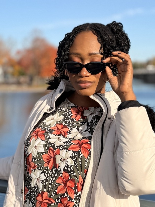 Ruova in sunglasses and a floral top